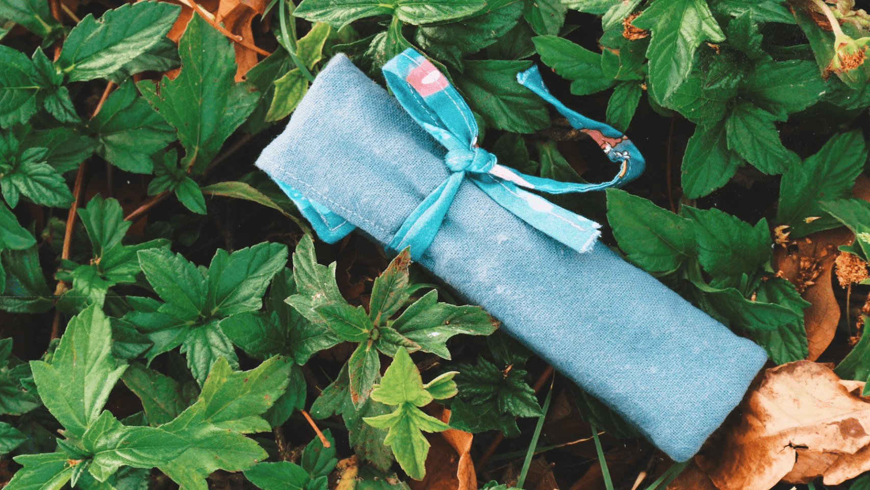 Charcoal knit cardigan displayed against a neutral wall